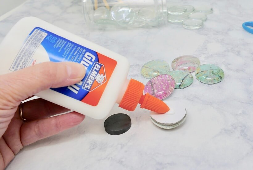 Glue All being applied to fridge magnet